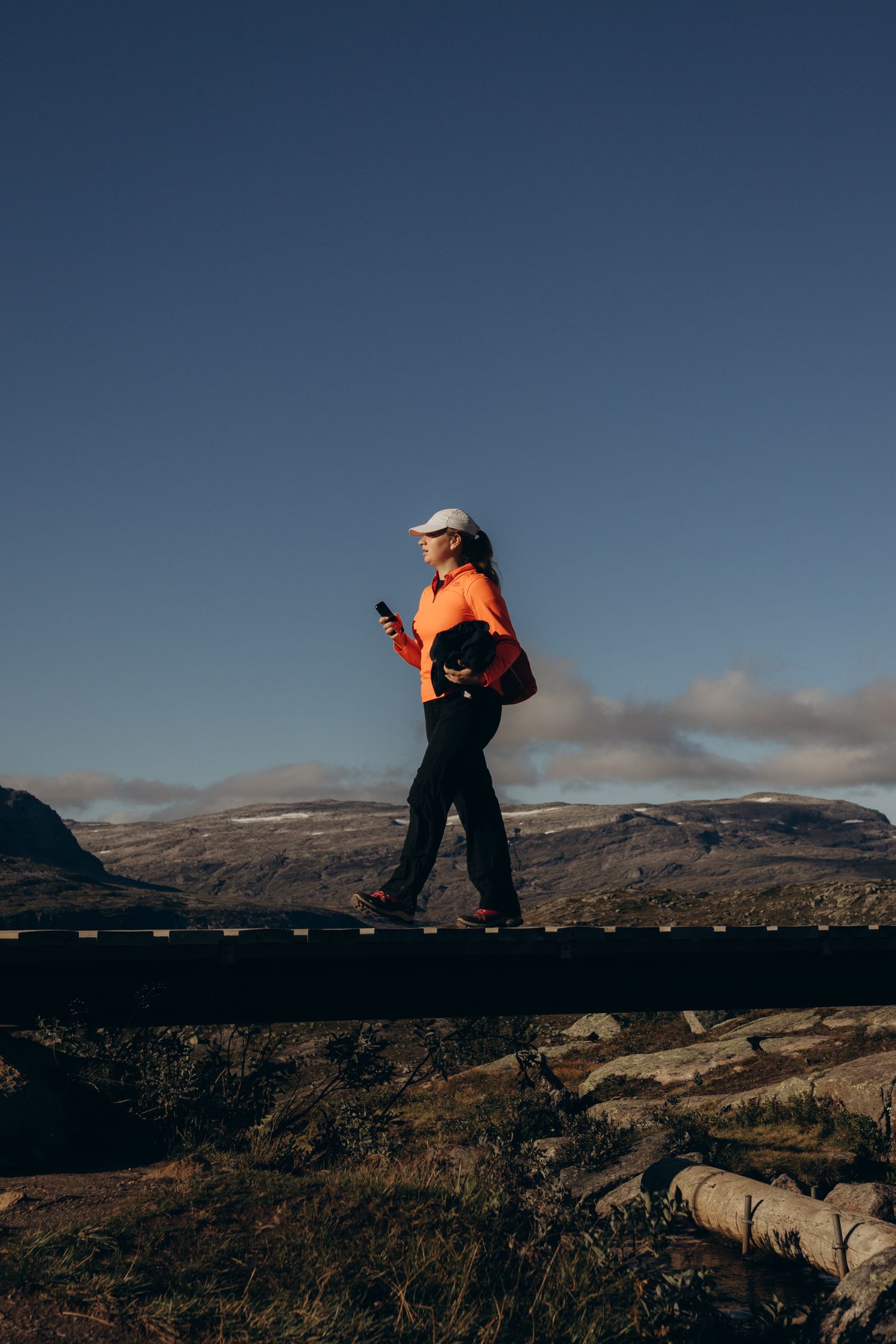 Hunter using a smartphone map in mountain terrain